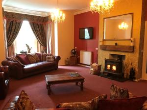 a living room with a couch and a fireplace at The Wighthill in Sandown