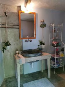 a bathroom with a sink and a mirror on a table at Holiday House Prodromos in Prodromos +120 photos