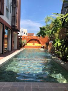 a swimming pool with a waterfall in the middle of a building at Nine Hotel Chiangmai in Chiang Mai