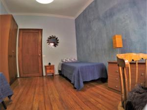 a bedroom with a bed and a dresser and a door at A Casa Mia in Las Palmas de Gran Canaria