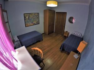 a small room with two beds and a table and a table at A Casa Mia in Las Palmas de Gran Canaria