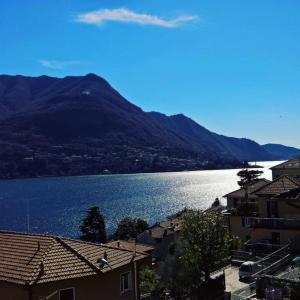 a large body of water with houses and a mountain at B&B "A Casa di Camilla" in Carate Urio