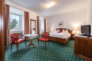 Postel nebo postele na pokoji v ubytování Hotel Weisse Lilie - B&B