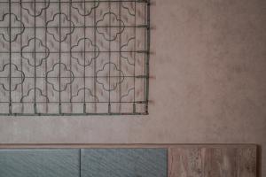 a window with a grate on a wall at Somer Hotel in Tainan