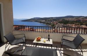 a balcony with a table and chairs and a view of the water at Bellagio in Castelsardo