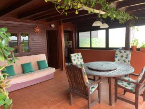 un patio con mesa, sillas y sofá en casa orymar en El Cotillo