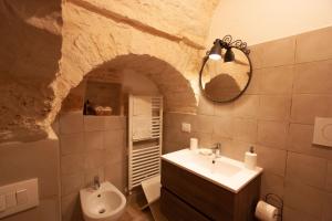 a bathroom with a sink and a toilet at Trullo Aprìco in Alberobello