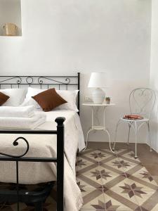 a bedroom with a black bed and a table at Trullo Aprìco in Alberobello