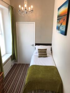 A bed or beds in a room at Wighthill Hotel 