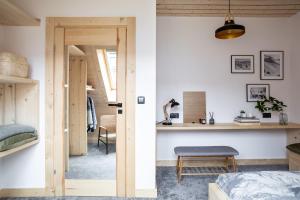 a bedroom with a bed and a desk in a room at Mount Apart Center in Zakopane