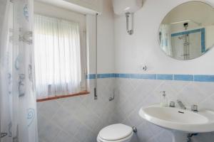 Tenuta Le Rocchette في Rocchette: حمام مع حوض ومرحاض ومرآة