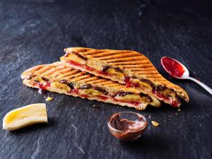 a waffle sandwich on a table with a spoon at ibis Hotel München Garching in Garching bei München