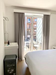 a bedroom with a bed and a desk and a balcony at Appartement Giulia in Knokke-Heist