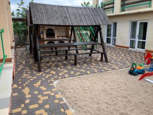 a playground with a bench and a play structure at Миндаль in Zatoka