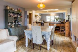 a kitchen with a dining room table and chairs at 4 bed family house with aga in Battle