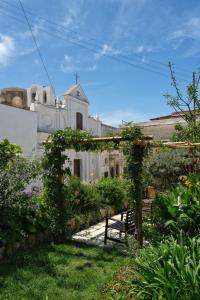 a garden in front of a building with a church at Le Cantinelle in Anacapri