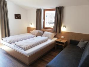 a bedroom with two beds and a window at Pramstaller Apartments in San Lorenzo di Sebato