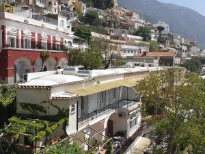 a building on top of a hill with houses at Regina Margherita in Positano