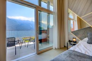 a bedroom with a balcony with a view of the ocean at Hotel Du Lac in Limone sul Garda