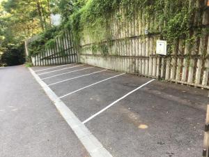 a row of empty parking spaces next to a wall at Skay Loft in Braşov