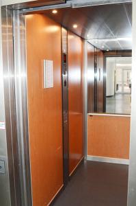 a row of elevator doors in an office building at Stephansstift Tagungs- und Gästehaus in Hannover