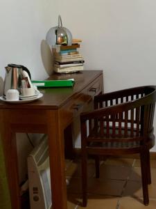 
a desk with a laptop, bookshelf and a chair at Ronda in Ronda
