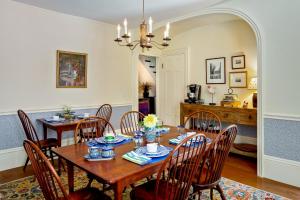 a dining room with a wooden table and chairs at Abigail's Inn in Camden