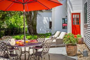 a table and chairs with an umbrella on a patio at Abigail's Inn in Camden