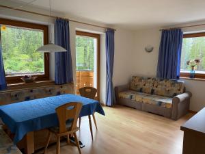 a living room with a table and a couch at Jausenstation Saege in Riva di Tures