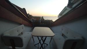 a stool on a balcony with a table and chairs at Görkemli Hotel in Istanbul