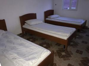 a room with three beds and a window and a floor at Motel California in Mărtineşti