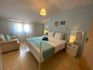 a bedroom with a large bed and a couch at Deep Blue Apartment in Poreč