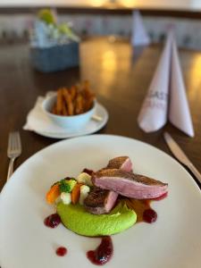 a plate of food with meat and vegetables on a table at Landgasthof Zahn in Elchingen