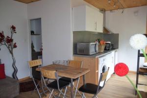 a kitchen with a table and chairs and a microwave at Little InterVal in Le Villard