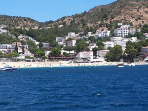 a view of a beach with buildings on a hill at Rosas-Puig Rom -VISTA MAR in Roses