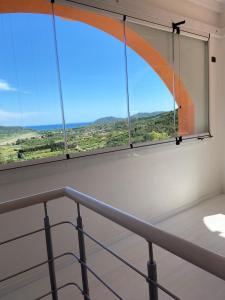 a room with a window with a view of the ocean at Residence Le Solane in Marina di Campo