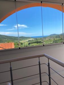 a view from the balcony of a building with windows at Residence Le Solane in Marina di Campo