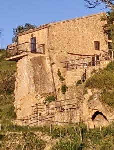 a building with a balcony on the side of it at La Casa Sulla roccia in Enna