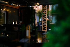 a bar with a man sitting at a table at WineWood Moscow in Moscow