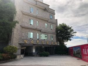 a building with a sign on the front of it at Royal Garden Motel - Chiayi Branch in Chiayi City