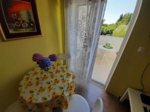 a cake with flowers on it sitting on a table in a room at Two bedroom ap in the garden in Buljarica