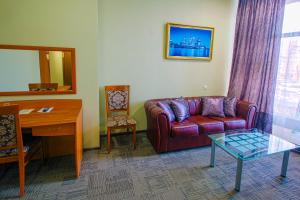 a living room with a couch and a table at Aer Hotel in Belgorod