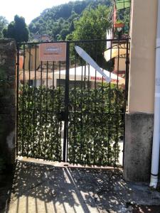 a gate with a hedge of plants behind it at Affittacamere l'Acciuga in La Spezia