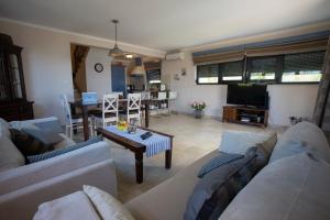 a living room with a couch and a table at Villa Oaza in Makarska