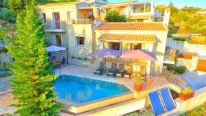 a villa with a swimming pool in front of a house at The Cassius Hill House in Kassiopi