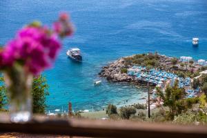 a view of a harbor with a boat in the water at Hamarat Otel in Kaş