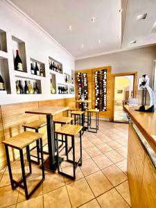 a restaurant with wooden tables and stools at Boutique Hotel Casa Mariantonia in Anacapri