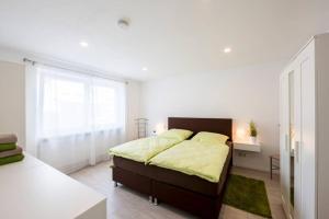 a bedroom with a bed and a large window at Ruhe und Entspannung in Erpolzheim