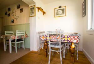 a dining room with chairs and a table at The Red Red Robin Cottage in Portree