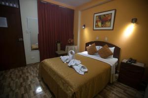 Postel nebo postele na pokoji v ubytování Hotel Suite Plaza